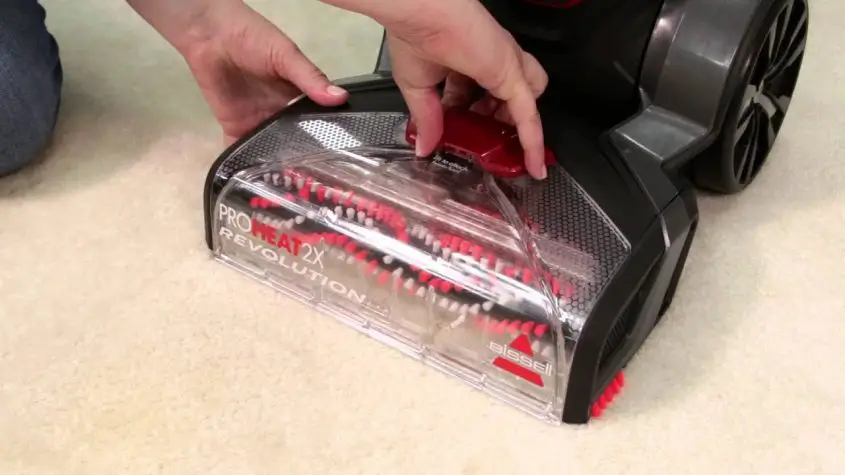 How do you open a Bissell carpet cleaner?